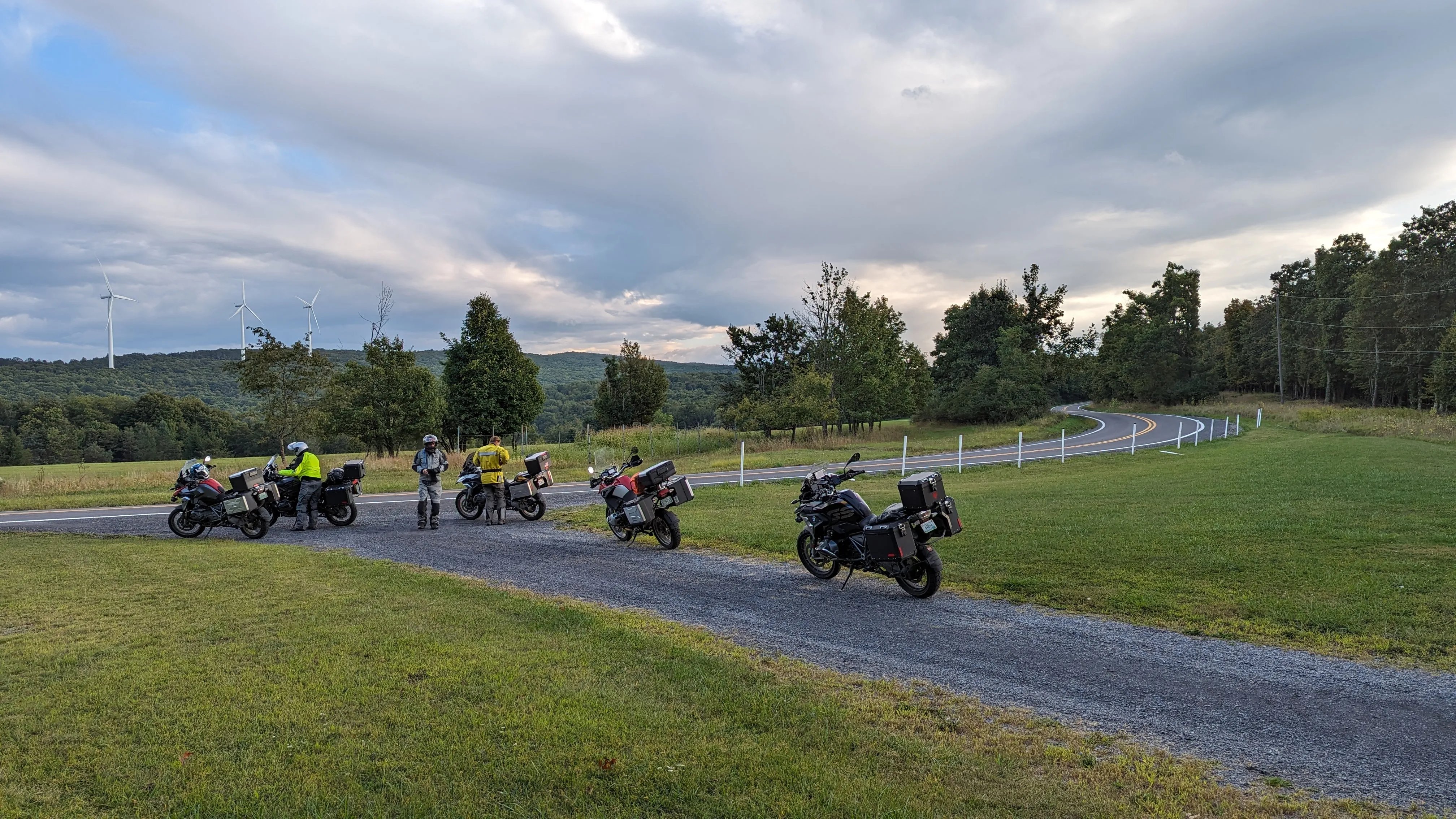 Motorcycles parked under windmills in West Virginia.
