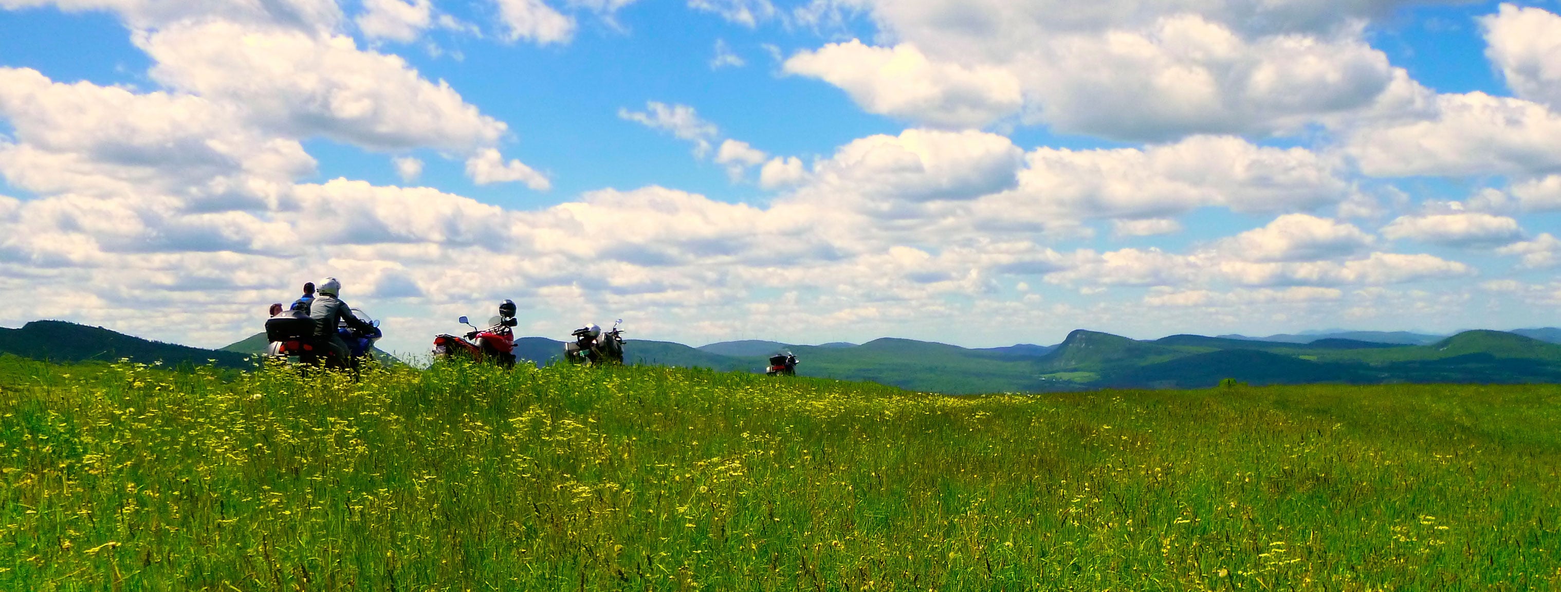 Motorcyclists admiring a view of mountains